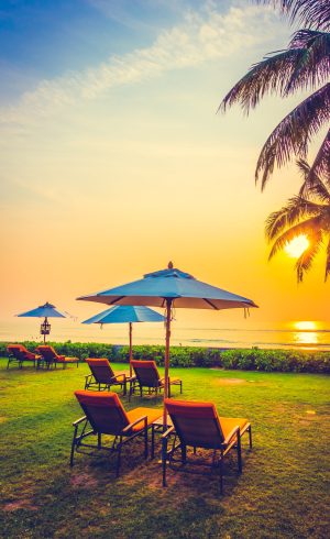 Empty umbrella and chair on the beach at Twilight Times - Vintage Filter